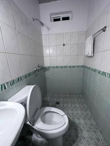 a bathroom with a toilet and a sink at Brisa del Mar #6 in Brisas de Zicatela