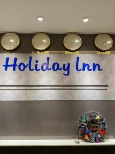 a display window of a holiday inn sign with clocks at Holiday Inn Hotel in Da Nang