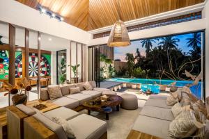 a living room with white furniture and a swimming pool at Villa Pearl by BaliSuperHost in Ubud