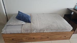 Una cama con una almohada azul encima. en 5350 Park inn Suite en Miami