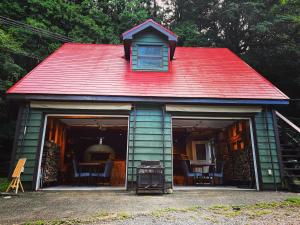 ein kleines Haus mit rotem Dach und Grill in der Unterkunft 帳 -TOBARI- in Dazaifu