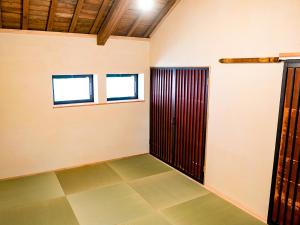 a room with a door and a tiled floor at GOYADO in Ozu