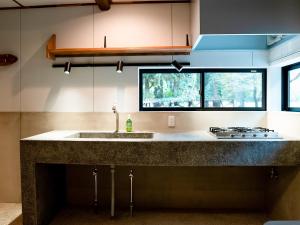 a kitchen with a sink and a stove at GOYADO in Ozu
