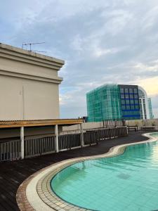 a swimming pool on the roof of a building at Riverbank Suites 805 in Kuching