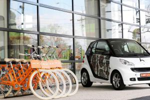 une voiture intelligente garée à côté d'une rangée de vélos dans l'établissement Art Series - The Larwill Studio, à Melbourne