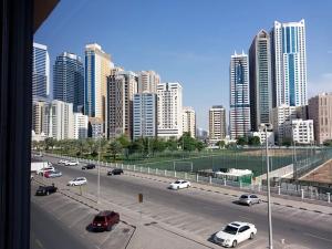 a view of a city with cars on a highway at Private Bedroom in a Home With Park View in Sharjah