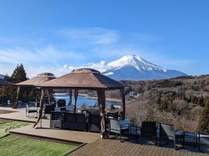 a view of a snow covered mountain from a deck at Rokumeikan Hills in Yamanakako