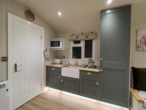 a kitchen with a sink and a microwave at Southfield Shepards Huts in Durham