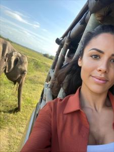 a woman sitting in a jeep looking at an elephant at Mahoora Udawalawe - by Eco Team in Udawalawe