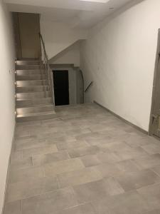 Habitación vacía con escalera y suelo de baldosa. en Zu Hause en Vrbov