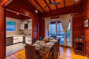 a kitchen and dining room with a table and chairs at StayVista at Villa Vivendi - 4 BR villa in Dharamshala in Dharamshala