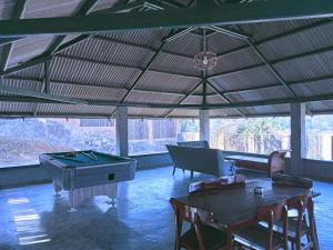 a large room with a ping pong table and a ping pong table at Villa Forest Puncak in Tagalbato