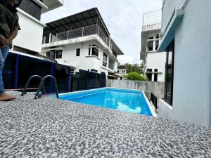 a swimming pool on the side of a building at Retreat Saujana rawang in Rawang