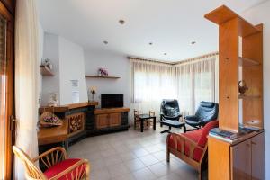 uma sala de estar com um sofá e uma televisão em Mas Espuña Turisme Entorn Rural em Sant Joan les Fonts