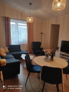 a living room with a couch and a table at Dawna Mleczarnia Apartament FAMILIJNY in Nowa Ruda