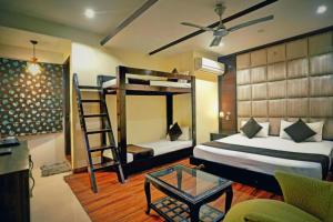 a bedroom with two bunk beds and a ladder at Staybook Hotel Aira, Paharganj, New Delhi Railway Station in New Delhi