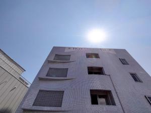 小田原市HOTEL POSH的太阳在上面的一座高楼