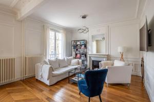 a living room with a couch and a chair at Jemmapes - Wonderful apartment near République place in Paris