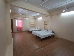 an empty room with two tables and a window at Nain Guest House in Ujjain
