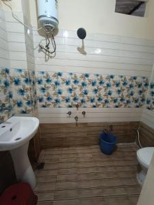a bathroom with a sink and a toilet at Nain Guest House in Ujjain