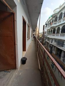 an empty corridor of a building with a balcony at Nain Guest House in Ujjain