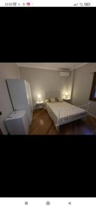 a bedroom with a bed and a sink and two lamps at La Terrazza Quisisana Sorrento Coast in Castellammare di Stabia