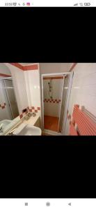 a small bathroom with a sink and a shower at La Terrazza Quisisana Sorrento Coast in Castellammare di Stabia