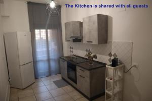 a kitchen with a sink and a refrigerator at Lavinia house in Lido di Ostia