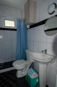 a bathroom with a toilet and a sink at Blue Apartments in Willemstad