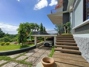 a porch of a house with a car parked under it at RedDoorz @ Green Homestay Syariah Baubau in Baubau