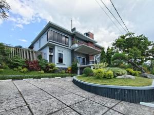 a house with a garden in front of it at RedDoorz @ Green Homestay Syariah Baubau in Baubau +40 photos