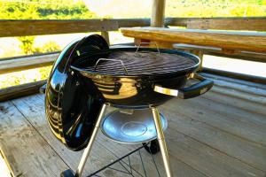 a black grill sitting on top of a deck at 四万十川まで歩いて行ける 一棟まるっと貸し切りの宿 gu in Shimanto