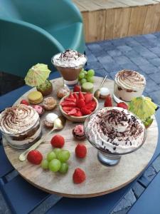 a table with desserts and fruit on a table at Cosykaza - SPA - Sauna - Hammam 