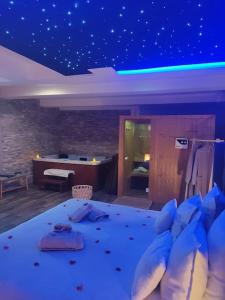 Un dormitorio con una cama con luces azules. en Cosykaza - SPA - Sauna - Hammam 