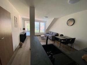 two views of a living room and a dining room at Černá Růže- Apartmán 5 in Pilsen