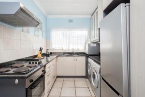 a kitchen with a refrigerator and a stove top oven at Breathtaking views from Sue Casa 11 in Margate