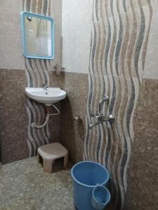 a bathroom with a sink and a shower and a bucket at Royal Nest Villa in Mahabaleshwar +30 photos