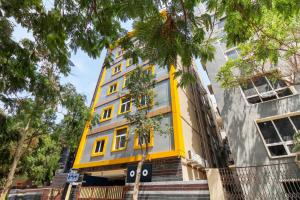 un bâtiment jaune avec des fenêtres sur une rue dans l'établissement New Cyber Grand Madhapur, à Kondapur
