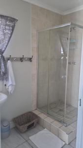a shower with a glass door in a bathroom at Bluewater Reservations in Port Elizabeth +23 photos