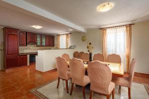 a kitchen and dining room with a table and chairs at Pool Villa Divina - Happy Rentals in Šišan