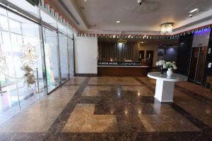 a lobby with a table in the middle of a room at The Bristol Inn Hotel in Dubai