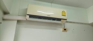 a projector hanging from the ceiling of a room at JATUPORN A3 in Ban Talat Rangsit