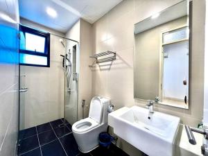 a bathroom with a sink and a toilet and a mirror at Citrine Hub in Sunway Iskandar by Cowidea in Kampong Pendas