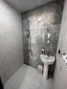 a bathroom with a shower and a sink at Villa Begonvil in Kuşadası