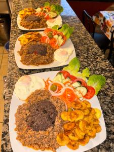 a table with three plates of food on it at Spa Rural Mirador de Miranda in Cutiellos