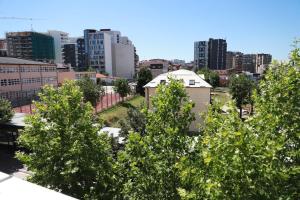 a city skyline with tall buildings and trees at HOTEL CITY in Pristina