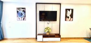 a living room with a tv on a wall at STAR APARTMENT- BEACH FRONT in Quy Nhon