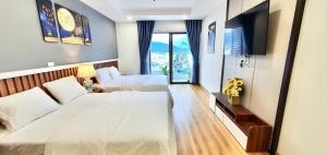 a hotel room with two beds and a television at STAR APARTMENT- BEACH FRONT in Quy Nhon