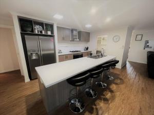 a kitchen with a white counter and a refrigerator at Shore Beats Workin in Esperance