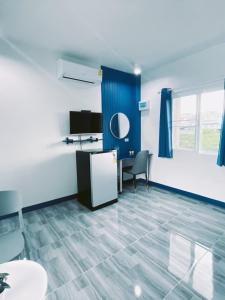 a room with a desk and a table and a chair at TJ Garden & Resort in Ban Dan Chang